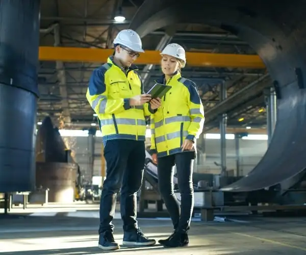 Photo of workers with large pipes